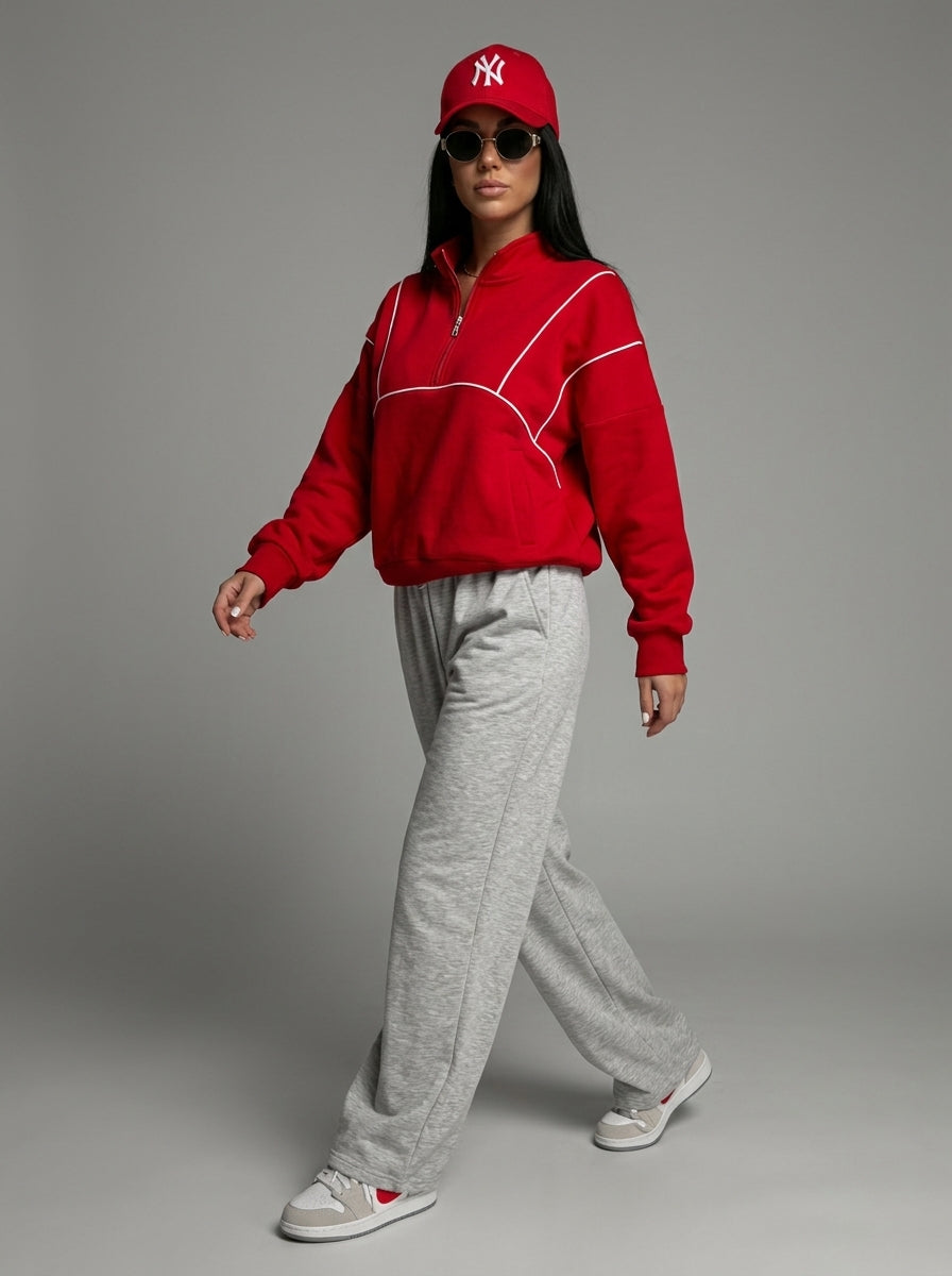 Femme qui marche en sweat demi-zip rouge et jogging large